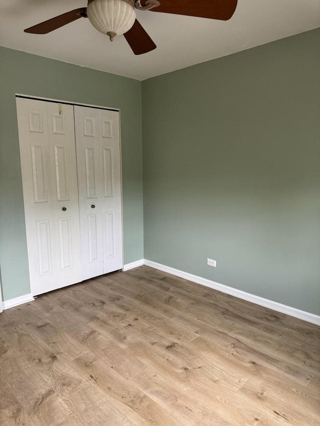 2404 Kenmore Ct, Schaumburg, IL 60193 - unfurnished bedroom featuring wood finished floors, a closet, and ceiling fan