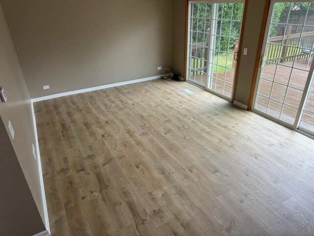 2404 Kenmore Ct, Schaumburg, IL 60193 - spare room featuring hardwood / wood-style flooring and baseboards