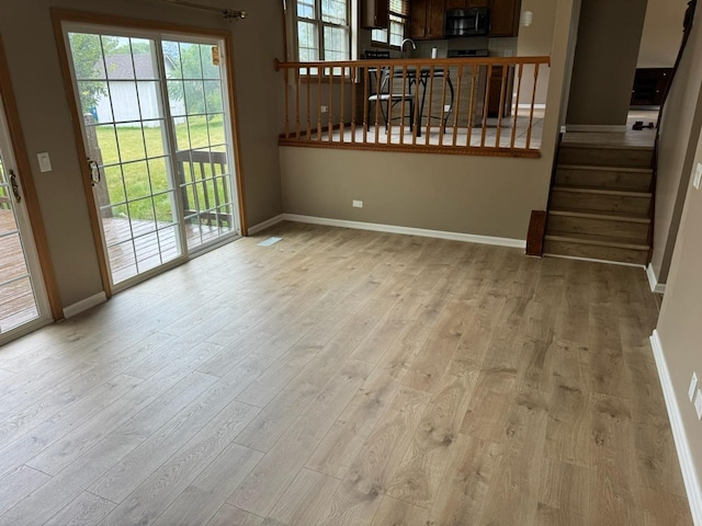 2404 Kenmore Ct, Schaumburg, IL 60193 - unfurnished living room with wood finished floors and stairs