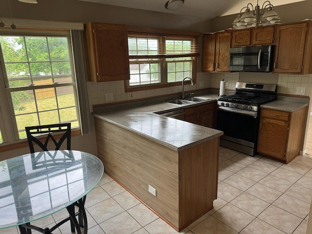 2404 Kenmore Ct, Schaumburg, IL 60193 - kitchen with appliances with stainless steel finishes, a peninsula, light tile patterned flooring, decorative backsplash, and lofted ceiling