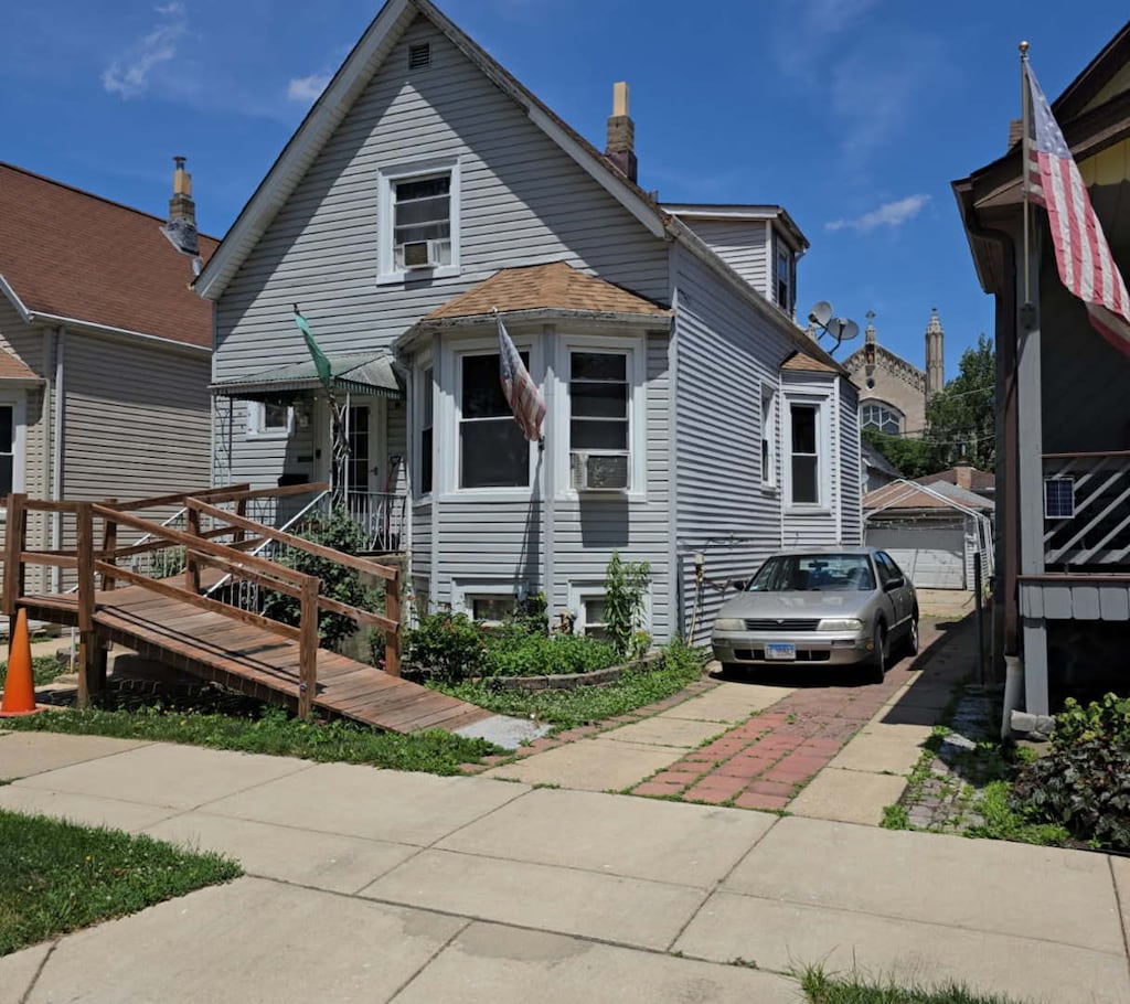 4160 W Eddy St, Chicago, IL 60641 - view of front facade featuring cooling unit and a detached garage