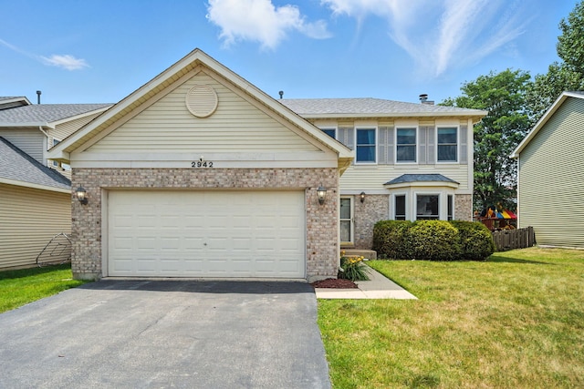2942 Heather Ln, Montgomery, IL 60538 - traditional-style home with driveway, brick siding, a front yard, and an attached garage