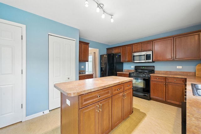 2942 Heather Ln, Montgomery, IL 60538 - kitchen with black appliances, light countertops, a center island, light floors, and brown cabinets