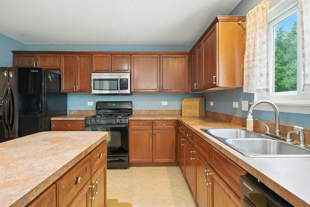 2942 Heather Ln, Montgomery, IL 60538 - kitchen with black appliances, healthy amount of natural light, light countertops, and brown cabinets