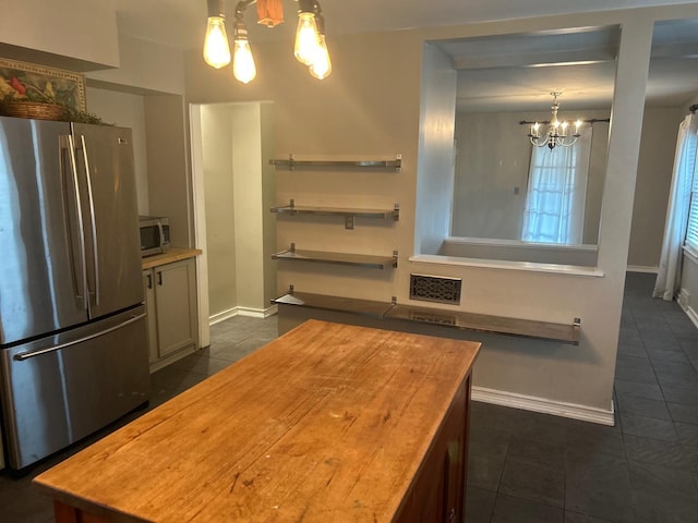 219 Spring Ave, Naperville, IL 60540 - kitchen featuring appliances with stainless steel finishes, a chandelier, dark tile patterned floors, butcher block counters, and pendant lighting