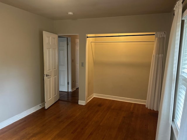 219 Spring Ave, Naperville, IL 60540 - unfurnished bedroom with dark wood-type flooring and baseboards