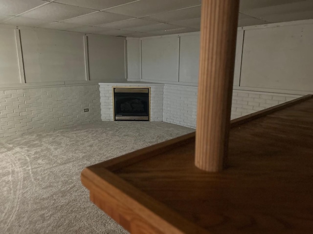 219 Spring Ave, Naperville, IL 60540 - finished below grade area with a drop ceiling, a brick fireplace, brick wall, and carpet