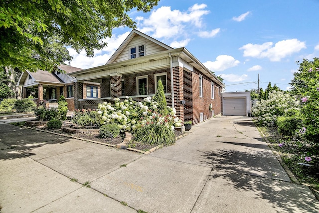 443 W Water St, Kankakee, IL 60901 - bungalow featuring brick siding, a porch, and a detached garage