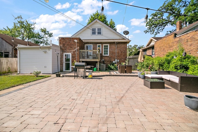 443 W Water St, Kankakee, IL 60901 - back of property with a patio area, brick siding, and outdoor lounge area