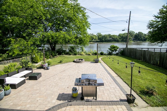 443 W Water St, Kankakee, IL 60901 - fenced backyard with a fire pit, a patio, a water view, and area for grilling