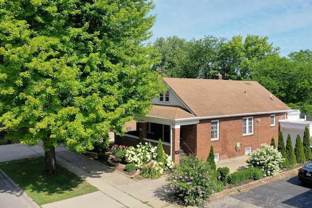 443 W Water St, Kankakee, IL 60901 - view of side of home with brick siding, a chimney, driveway, and a shingled roof