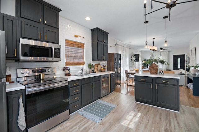 443 W Water St, Kankakee, IL 60901 - kitchen featuring stainless steel appliances, light countertops, light wood-type flooring, and recessed lighting