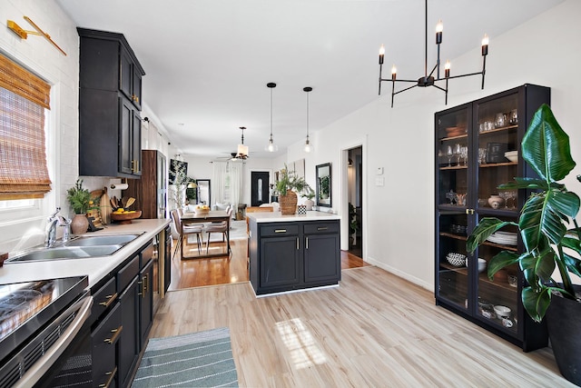 443 W Water St, Kankakee, IL 60901 - kitchen featuring light countertops, light wood finished floors, decorative light fixtures, a chandelier, and a ceiling fan