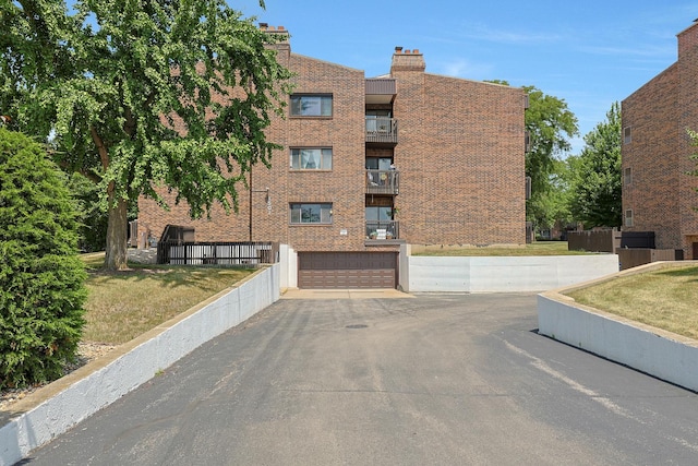1501 Woodbridge Rd Unit 3E, Joliet, IL 60436 - view of property featuring a garage and asphalt driveway