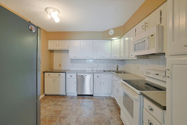 1501 Woodbridge Rd Unit 3E, Joliet, IL 60436 - kitchen featuring appliances with stainless steel finishes, a textured ceiling, decorative backsplash, and white cabinets
