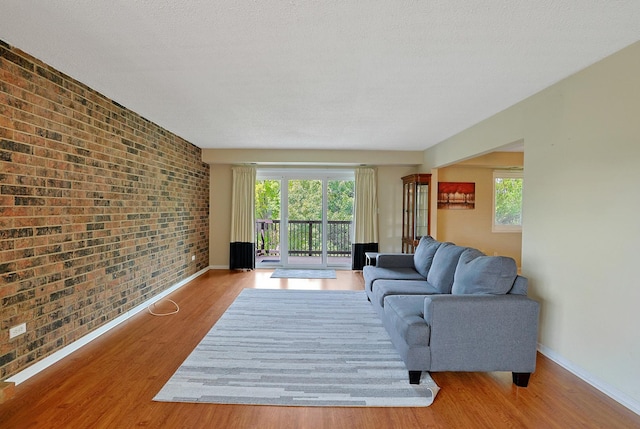 1501 Woodbridge Rd Unit 3E, Joliet, IL 60436 - living room featuring brick wall and wood finished floors