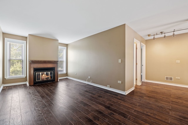 3050 Ashton Ct, Westchester, IL 60154 - unfurnished living room with a glass covered fireplace, dark wood finished floors, and rail lighting