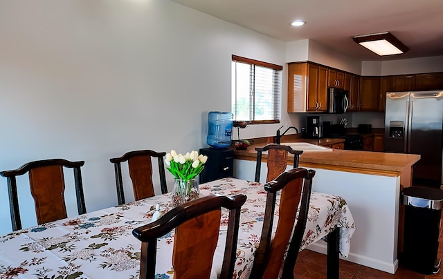 3113 Meadowsedge Ln, Joliet, IL 60436 - kitchen featuring stainless steel appliances, a peninsula, dark tile patterned flooring, and recessed lighting