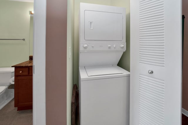 1151 W 15th St Unit 336, Chicago, IL 60608 - washroom with stacked washer / dryer and tile patterned floors