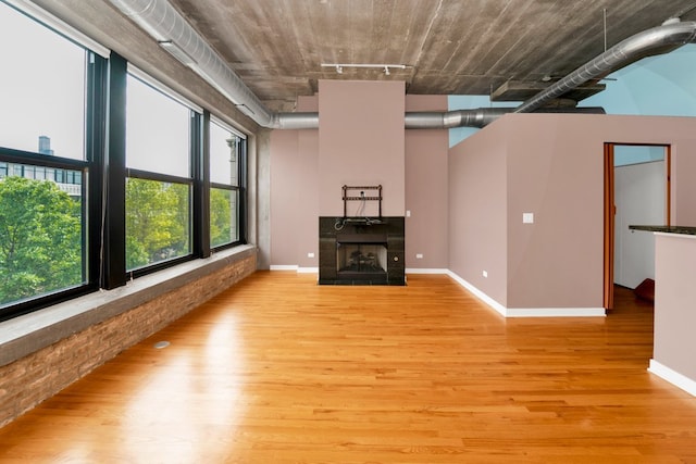 1151 W 15th St Unit 336, Chicago, IL 60608 - unfurnished living room featuring light wood-style floors, track lighting, and a tile fireplace