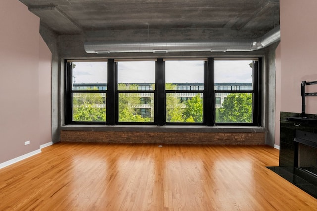 1151 W 15th St Unit 336, Chicago, IL 60608 - unfurnished living room with wood finished floors and baseboards