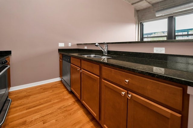 1151 W 15th St Unit 336, Chicago, IL 60608 - kitchen with stainless steel appliances, light wood-style flooring, dark stone counters, and brown cabinets