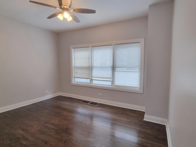 empty room featuring dark wood-style flooring and ceiling fan