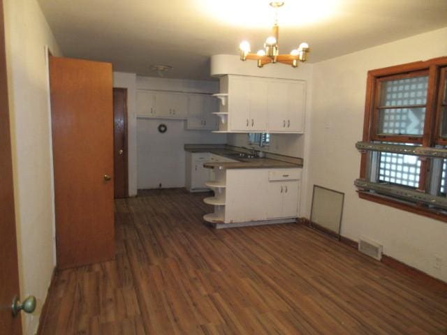 7700 S Ada St, Chicago, IL 60620 - kitchen with open shelves, a chandelier, white cabinetry, and dark wood-type flooring