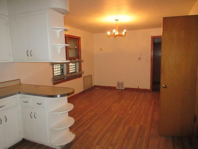7700 S Ada St, Chicago, IL 60620 - kitchen featuring open shelves, a chandelier, wood finished floors, white cabinetry, and dark countertops
