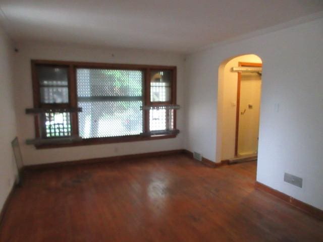 7700 S Ada St, Chicago, IL 60620 - spare room featuring arched walkways and wood finished floors