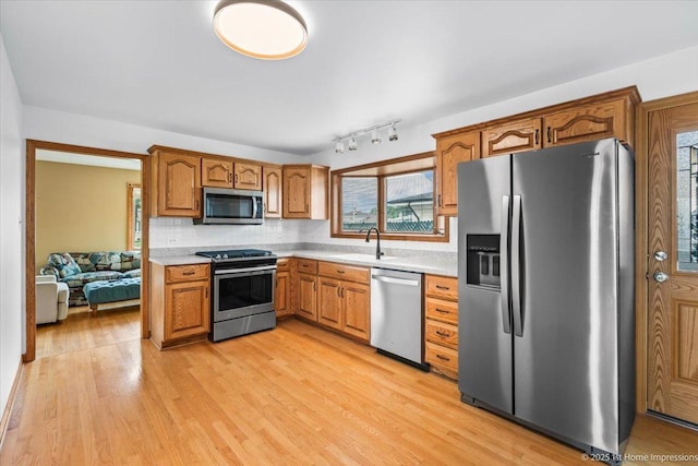 4616 W 105th Pl, Oak Lawn, IL 60453 - kitchen featuring appliances with stainless steel finishes, light countertops, brown cabinets, and decorative backsplash