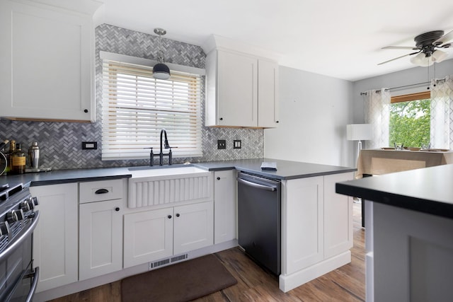 235 Parktrail Ct, Schaumburg, IL 60173 - kitchen with appliances with stainless steel finishes, a peninsula, ceiling fan, wood finished floors, and dark countertops
