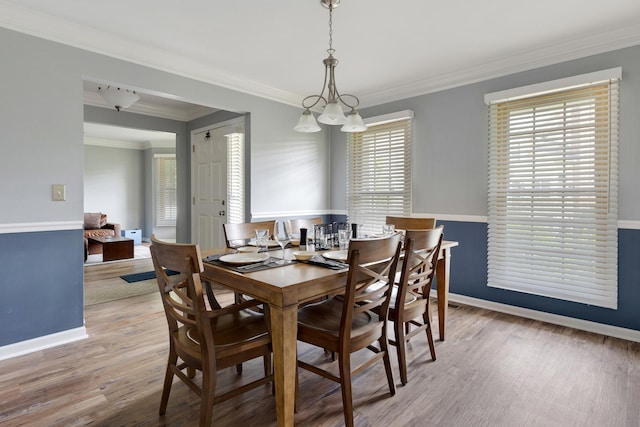 235 Parktrail Ct, Schaumburg, IL 60173 - dining room with wood finished floors, ornamental molding, and a chandelier
