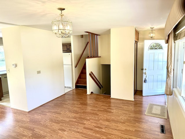 36429 N Edgewood Dr, Gurnee, IL 60031 - foyer entrance with a chandelier, light wood-style flooring, and stairway