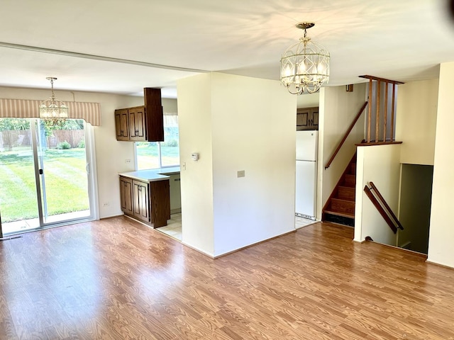 36429 N Edgewood Dr, Gurnee, IL 60031 - kitchen with a chandelier, freestanding refrigerator, light wood-type flooring, and dark brown cabinets