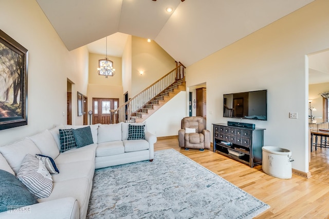 9299 Lee Hill Rd, Newark, IL 60541 - living room featuring a chandelier, wood finished floors, high vaulted ceiling, and stairway