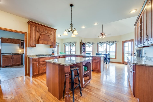 9299 Lee Hill Rd, Newark, IL 60541 - kitchen with premium range hood, a peninsula, brown cabinetry, light wood-style floors, and recessed lighting