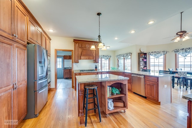 9299 Lee Hill Rd, Newark, IL 60541 - kitchen featuring appliances with stainless steel finishes, a kitchen island, brown cabinets, open shelves, and light wood-type flooring