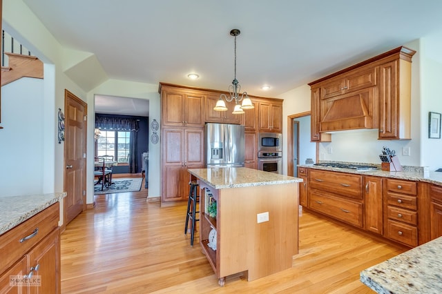 9299 Lee Hill Rd, Newark, IL 60541 - kitchen with appliances with stainless steel finishes, light wood finished floors, a kitchen island, and custom exhaust hood
