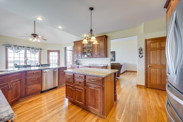 9299 Lee Hill Rd, Newark, IL 60541 - kitchen featuring stainless steel appliances, light wood finished floors, a ceiling fan, decorative light fixtures, and vaulted ceiling