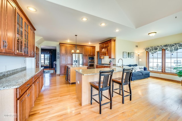 9299 Lee Hill Rd, Newark, IL 60541 - kitchen with stainless steel appliances, light wood finished floors, a peninsula, light stone counters, and recessed lighting