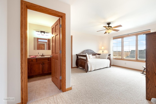 9299 Lee Hill Rd, Newark, IL 60541 - bedroom with light colored carpet, ensuite bathroom, light tile patterned floors, and ceiling fan
