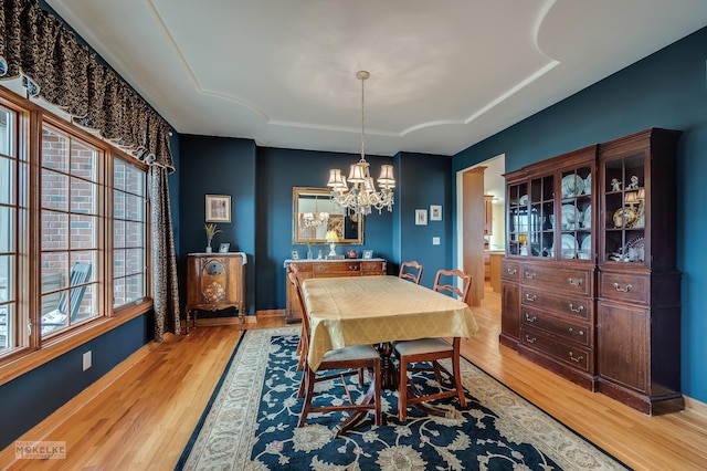 9299 Lee Hill Rd, Newark, IL 60541 - dining space with a chandelier, light wood-type flooring, and a raised ceiling