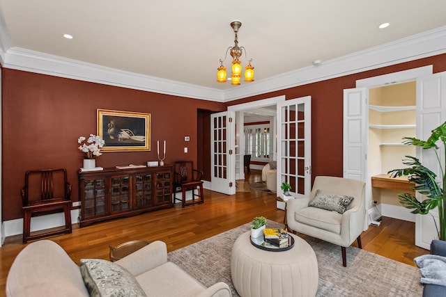 2423 Harrison St, Evanston, IL 60201 - living room featuring french doors, a chandelier, ornamental molding, and wood finished floors