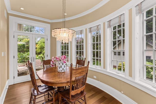 2423 Harrison St, Evanston, IL 60201 - dining space with plenty of natural light, dark wood finished floors, ornamental molding, french doors, and a chandelier