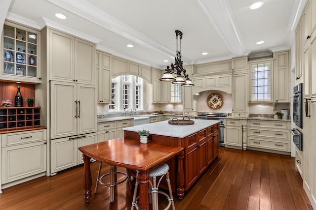2423 Harrison St, Evanston, IL 60201 - kitchen with stainless steel appliances, dark wood-type flooring, backsplash, a warming drawer, and ornamental molding
