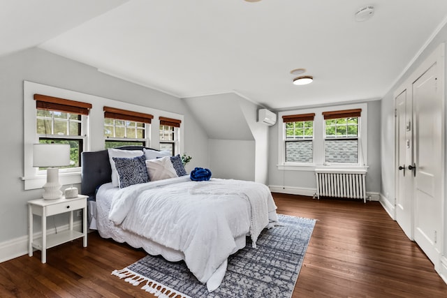 2423 Harrison St, Evanston, IL 60201 - bedroom featuring radiator heating unit, lofted ceiling, an AC wall unit, wood finished floors, and multiple windows