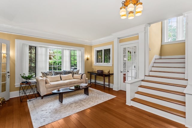 2423 Harrison St, Evanston, IL 60201 - living room featuring plenty of natural light, wood-type flooring, stairs, a chandelier, and ornamental molding