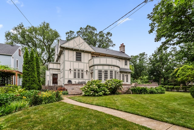 2423 Harrison St, Evanston, IL 60201 - back of property featuring french doors, a chimney, a yard, a balcony, and stucco siding