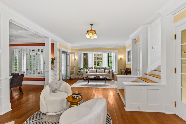 2423 Harrison St, Evanston, IL 60201 - living room featuring light wood-style flooring, a chandelier, stairs, and ornamental molding